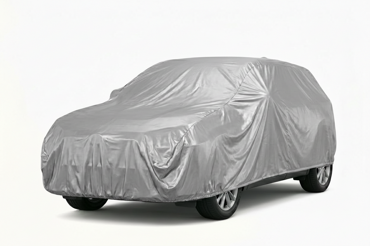 Car covered with a silver car cover on a white background