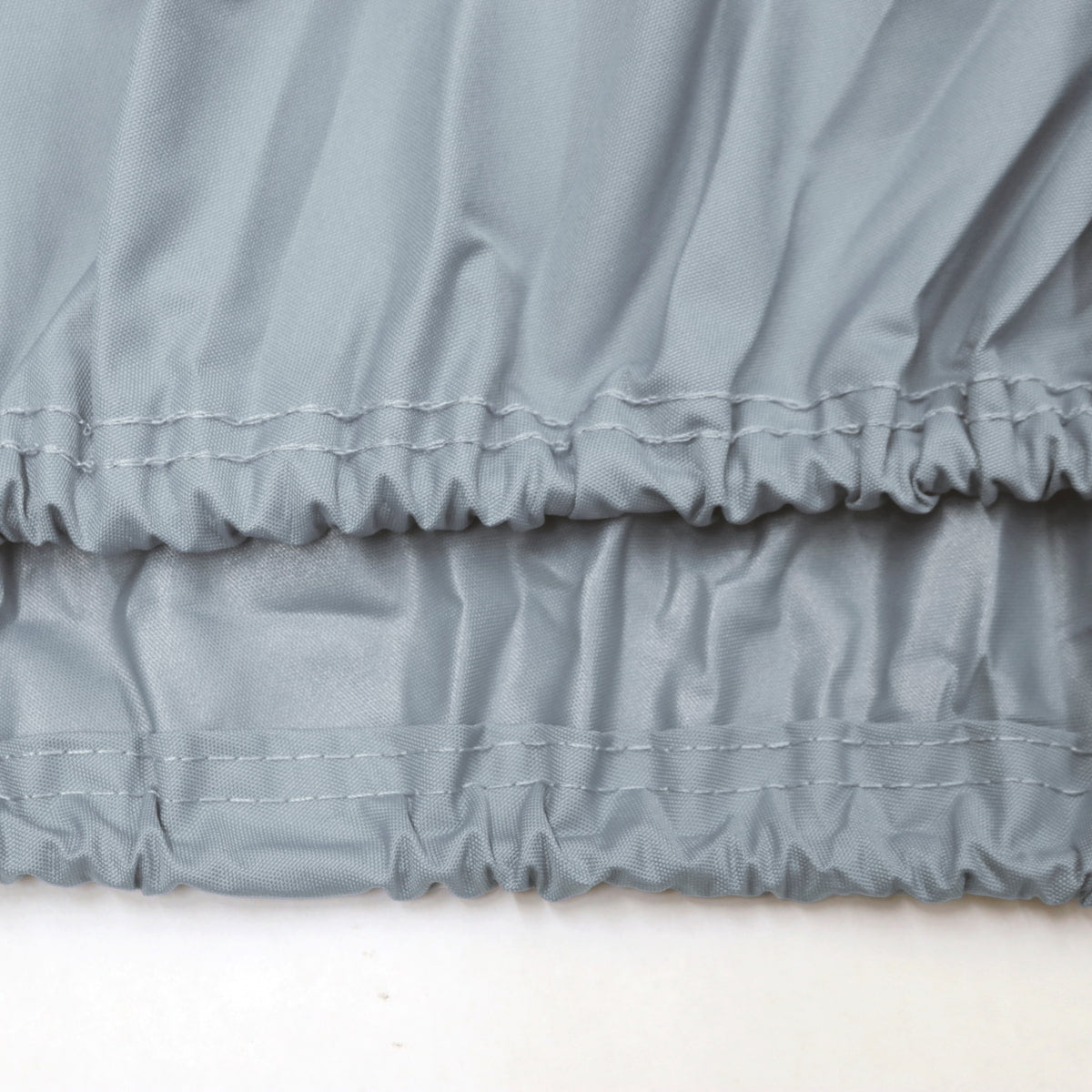 Close-up of gray ruffled fabric on a white background